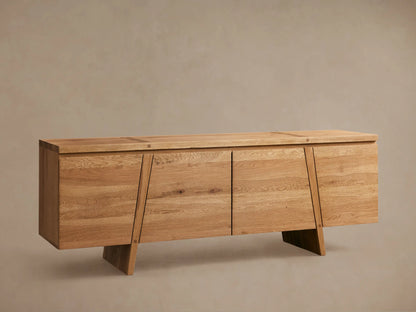 Panta Sideboard in light wood finish with four doors, angled side legs, and a flat top, set against a neutral wall.