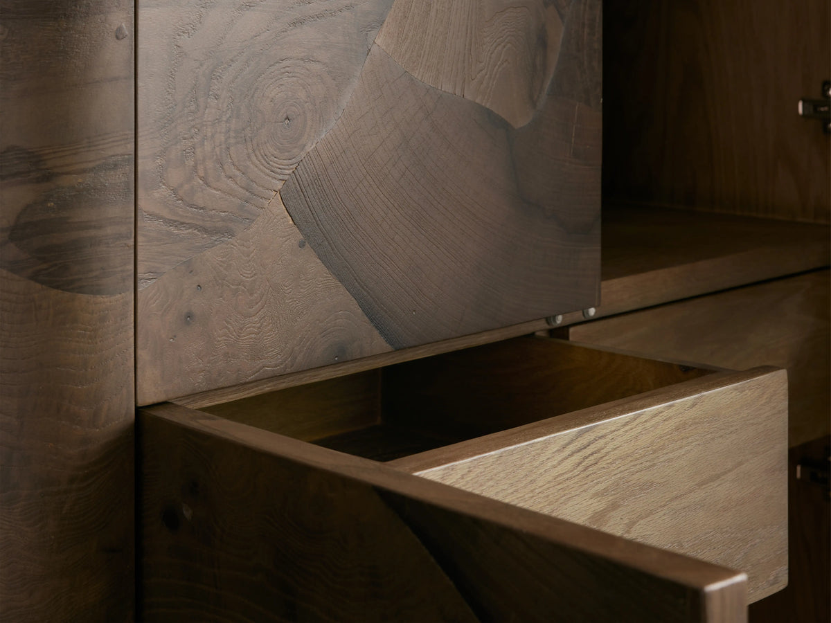 Open drawer of a Polanco Cabinet showing the detailed oyster-cut ash wood with natural grain patterns and hand-applied finish.
