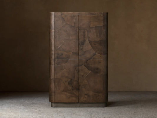 Polanco Cabinet in natural wood finish, showcasing oyster-cut patterns and unique graining. Stands on weathered steel base.