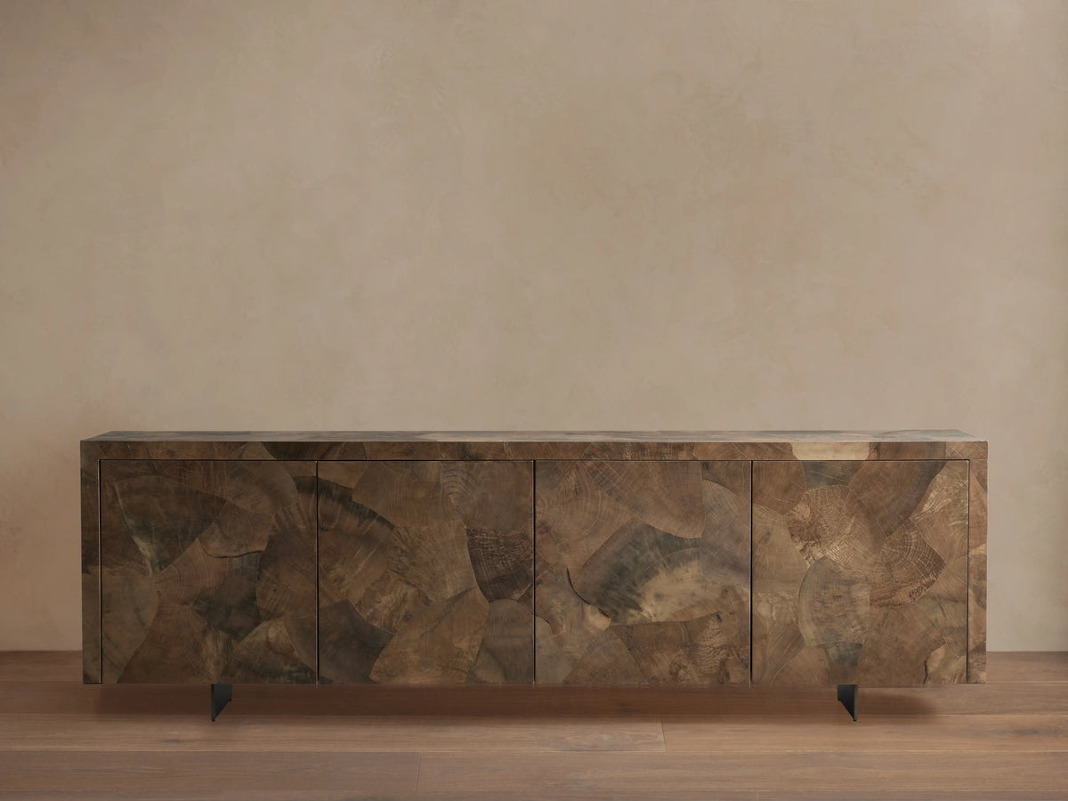 Polanco Sideboard with a rectangular shape, featuring a textured wood finish with varying earthy tones, resting on dark steel legs.