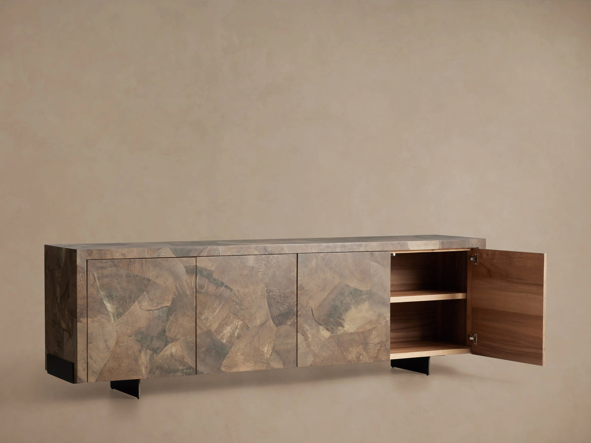 Polanco Sideboard with a rectangular shape, featuring a textured wood finish with varying earthy tones, resting on dark steel legs.