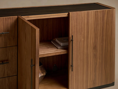 Piermont Sideboard: long walnut wood with smoked glass top and bronze plinth base. Rightmost door open, showing interior shelves.