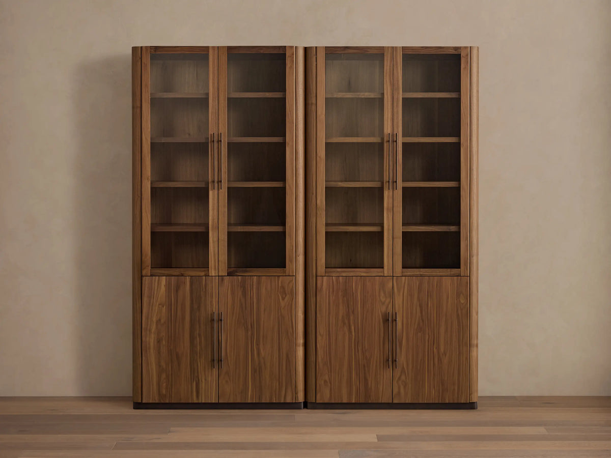 Pair of Piermont Modular Glass Cabinets in dark walnut wood with upper glass doors, lower solid doors, rounded tops, bronze base.