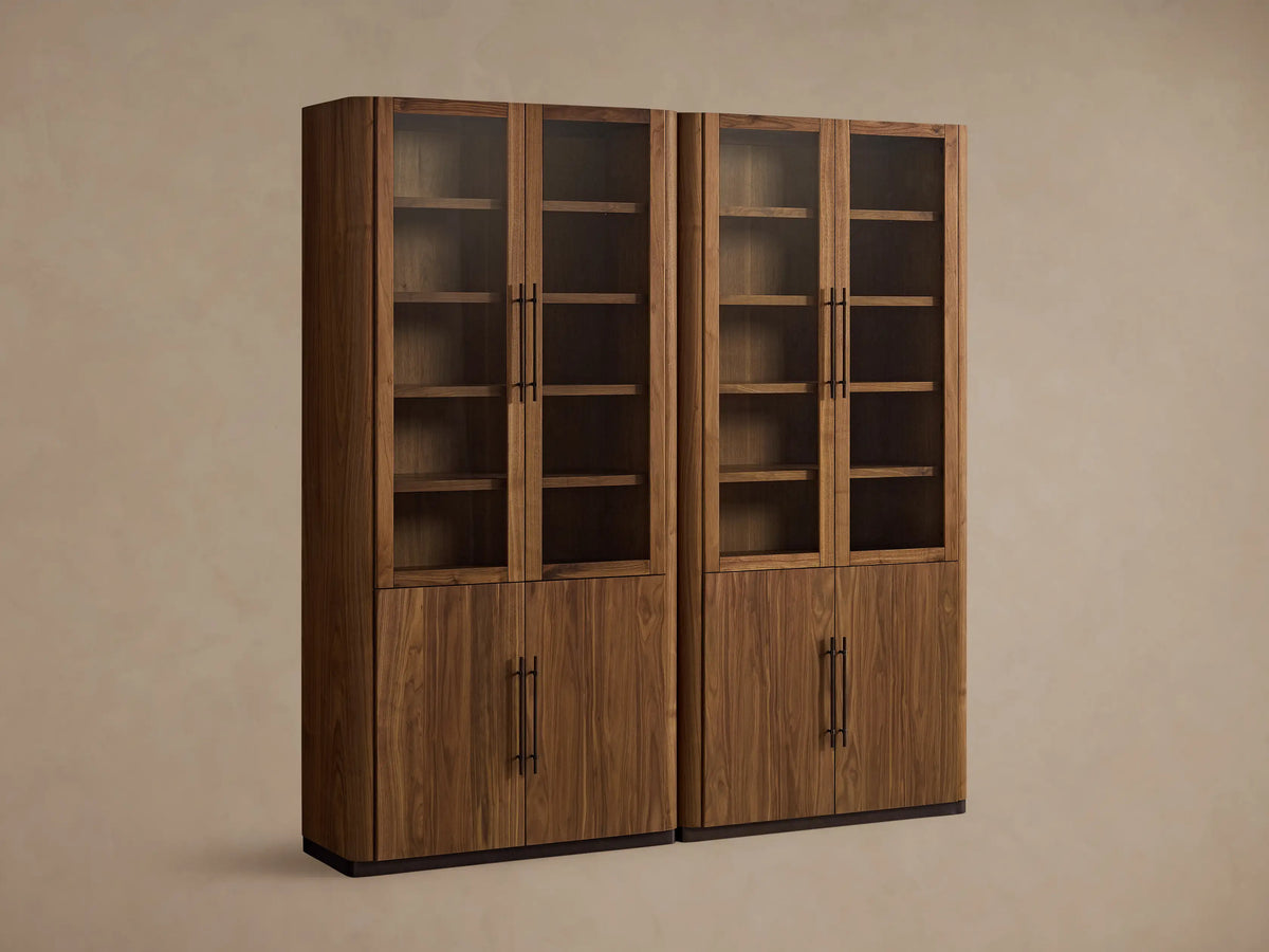 Close-up of Piermont Modular Glass Cabinet; dark walnut wood, clear glass doors with bronze handles, and wooden shelves.