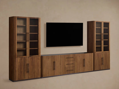 Angled view of Piermont Modular Glass Media Cabinet. Open drawer shows interior. Rich walnut wood grain, dark bronze handles, black top.