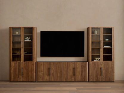 Piermont Modular Glass Media Cabinet Set: dark walnut wood console under TV, flanked by two tall glass-door display cabinets.