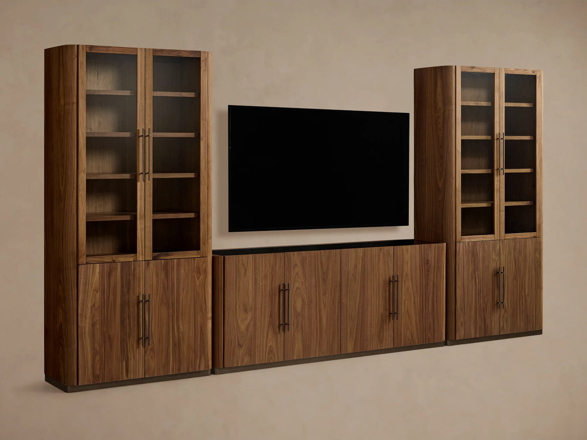 Piermont Modular Glass Media Cabinet Set: dark walnut wood console under TV, flanked by two tall glass-door display cabinets.