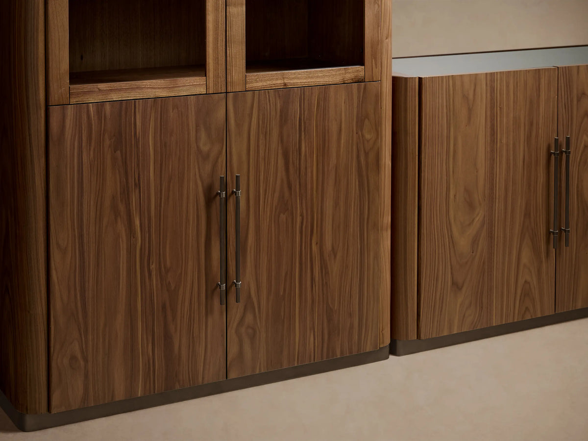 Piermont Modular Glass Media Cabinet Set: Two tall glass-door dark walnut units flanking a shorter solid-door console on bronze bases.