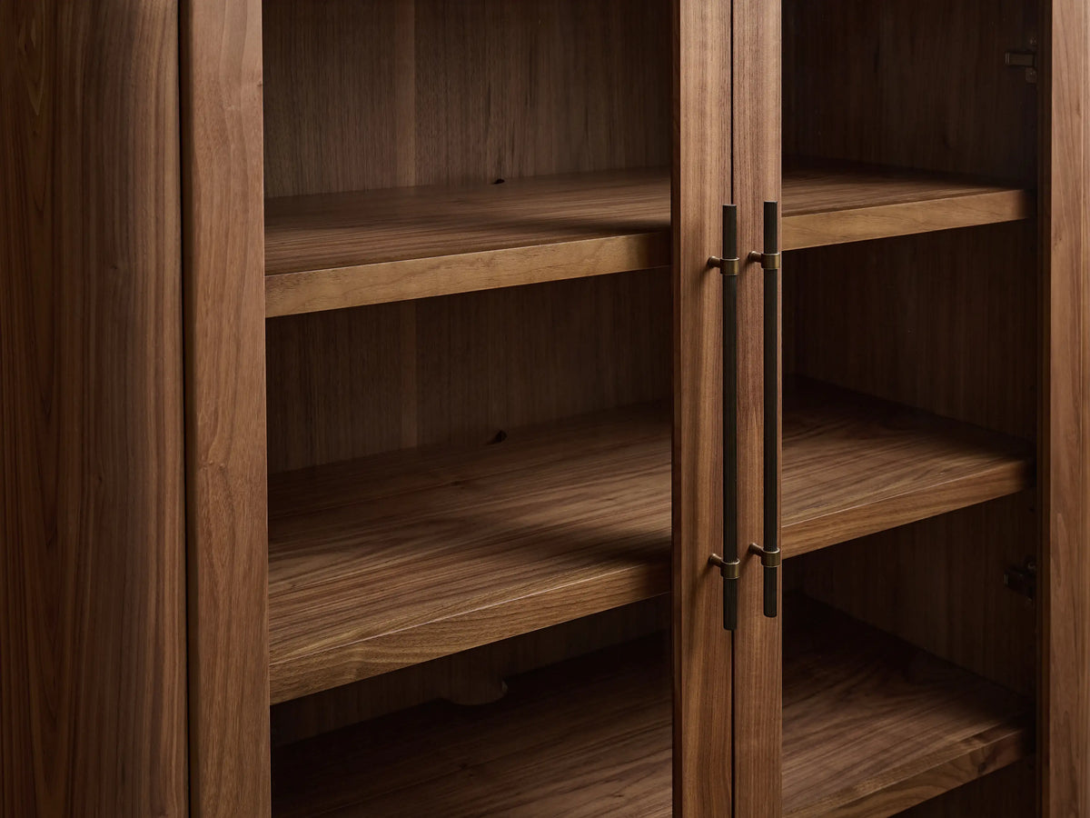 Piermont Modular Glass Media Cabinet: dark walnut, right sliding door slightly open, revealing shelves & cord hole. Bronze handle, dark top.