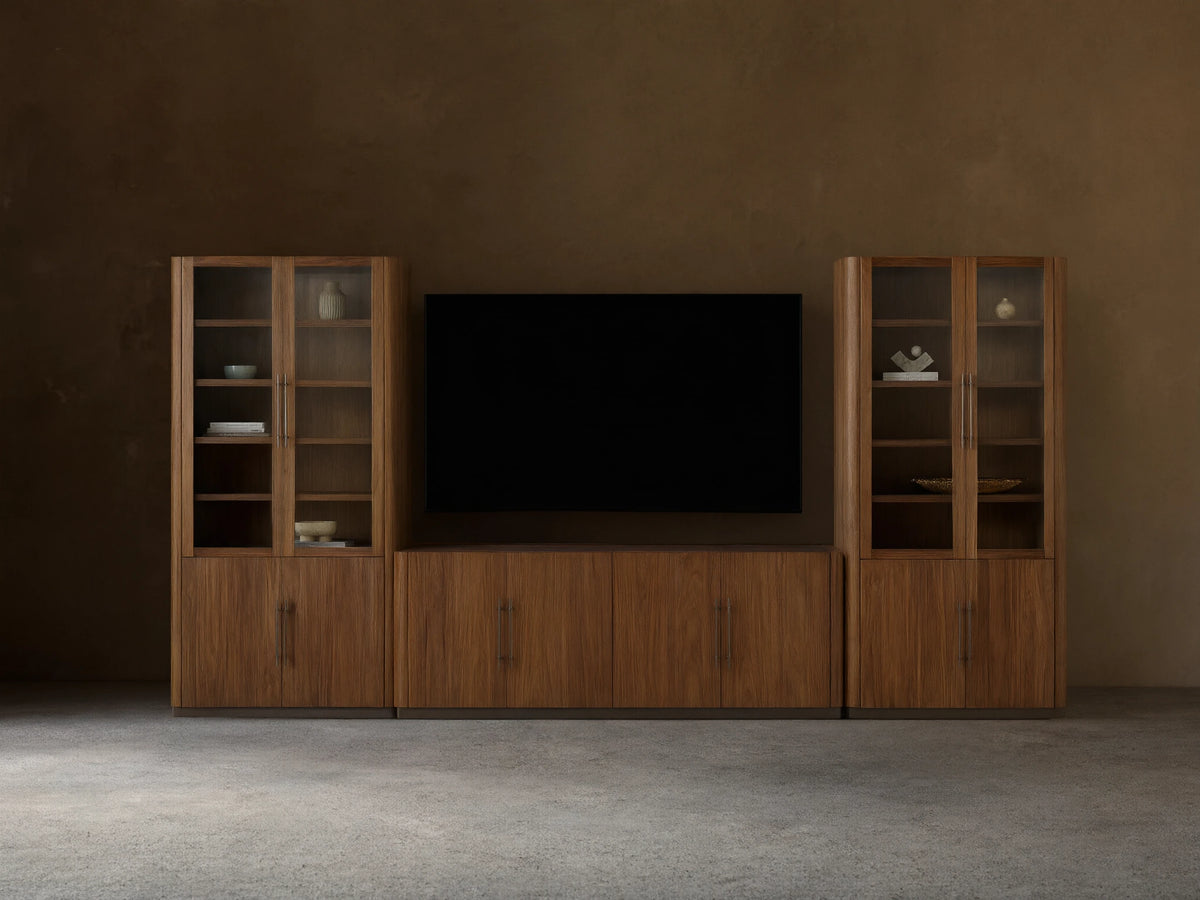 Piermont Modular Glass Media Cabinet Set: dark walnut wood console under TV, flanked by two tall glass-door display cabinets.