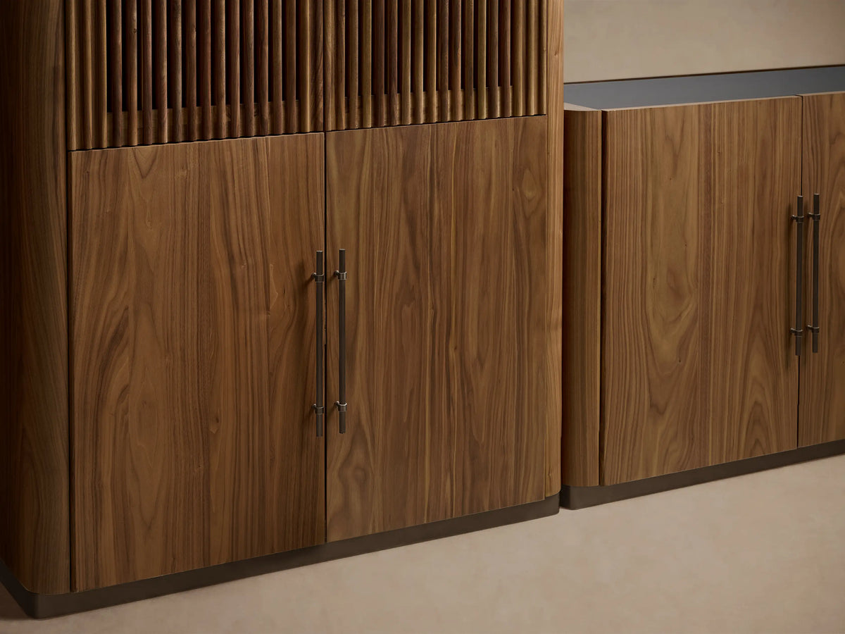 Piermont Modular Reeded Media Cabinet Set with Drawers in dark walnut wood with bronze plinth, centered around a TV.