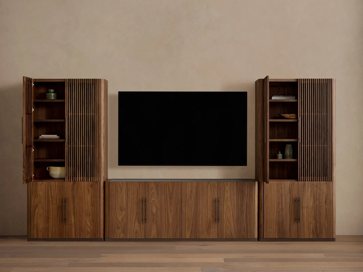 Piermont Modular Reeded Media Cabinet Set: Dark walnut wood set, central media console with black TV, two tall side cabinets with reeded doors ajar.