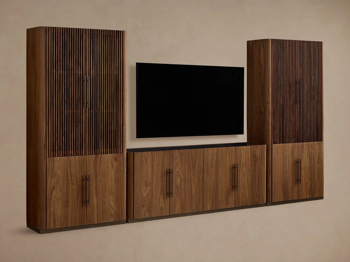 Piermont Modular Reeded Media Cabinet Set: Dark walnut wood set, central media console with black TV, two tall side cabinets with reeded doors ajar.