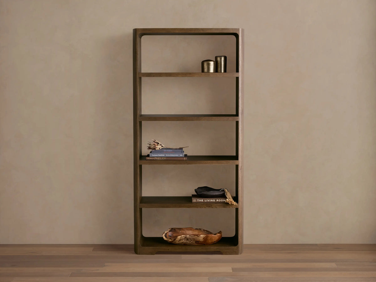 Front view of the dark reclaimed oak Redding Bookcase with five open shelves and rounded corners, styled with home decor.
