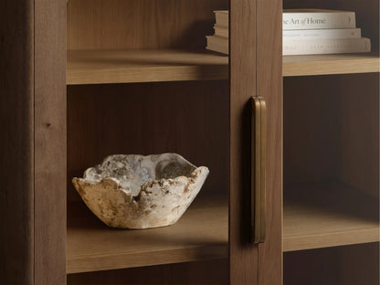 Close-up of the Redding Glass Cabinet with a glass door, reclaimed white oak frame, and antique brass handle. Interior holds a decorative bowl.