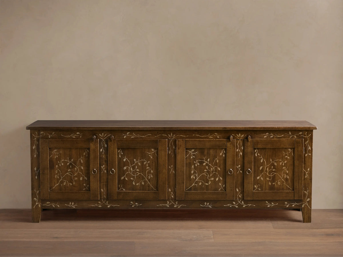 Front view of the brown Stefania Four-Door Buffet, featuring hand-painted gold vine decor and antique ring-pull hardware.