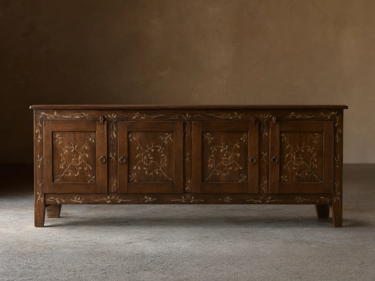 Front view of the brown Stefania Four-Door Buffet, featuring hand-painted gold vine decor and antique ring-pull hardware.