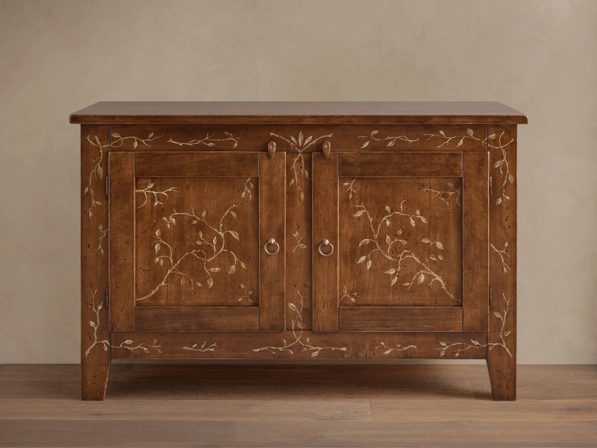 Stefania Buffet: brown poplar wood cabinet with two doors, hand-painted light vine decor, and antique bronze ring pull hardware.