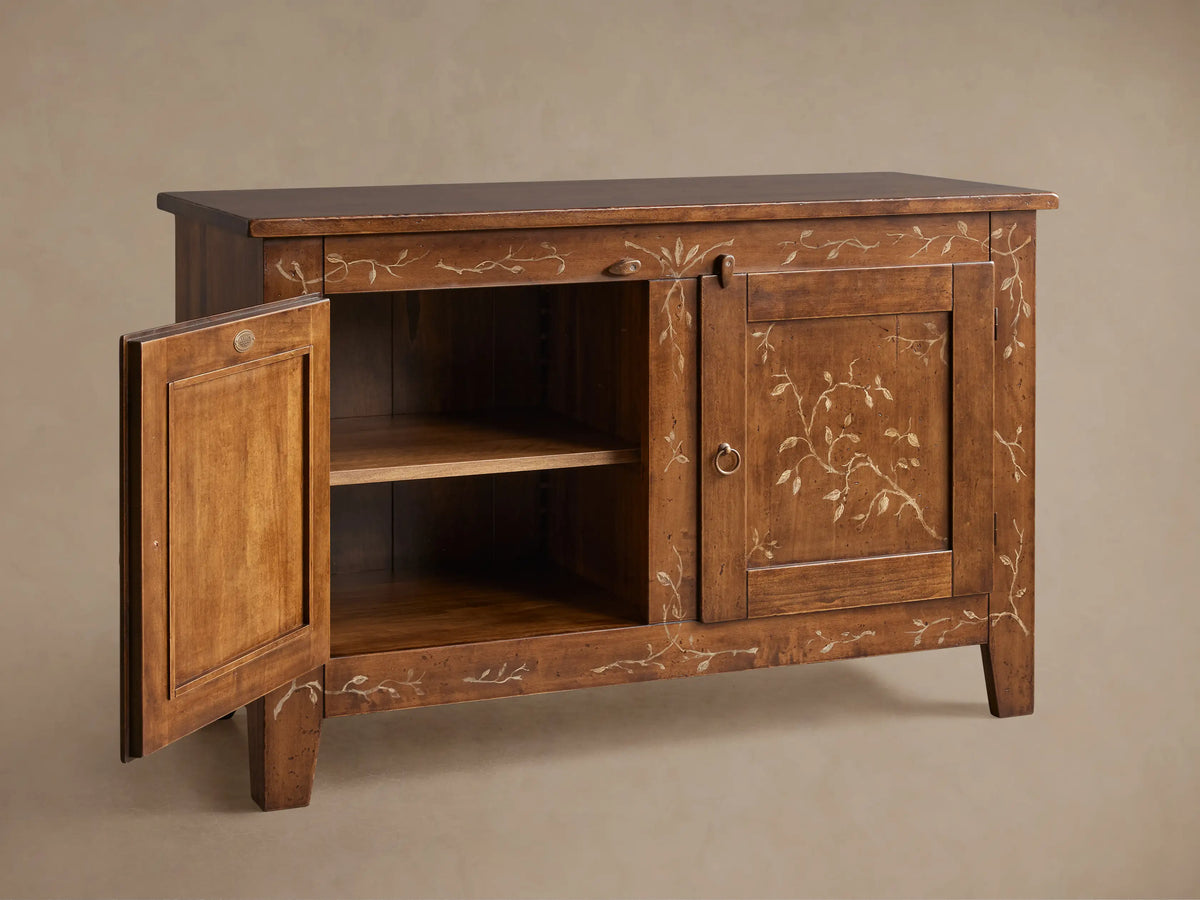 Stefania Buffet: brown poplar wood cabinet with two doors, hand-painted light vine decor, and antique bronze ring pull hardware.