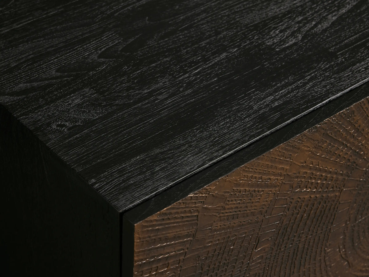 Theota Sideboard, dark wooden cabinet with textured bronze sunburst doors, far right door open revealing dark shelves, on metal legs.