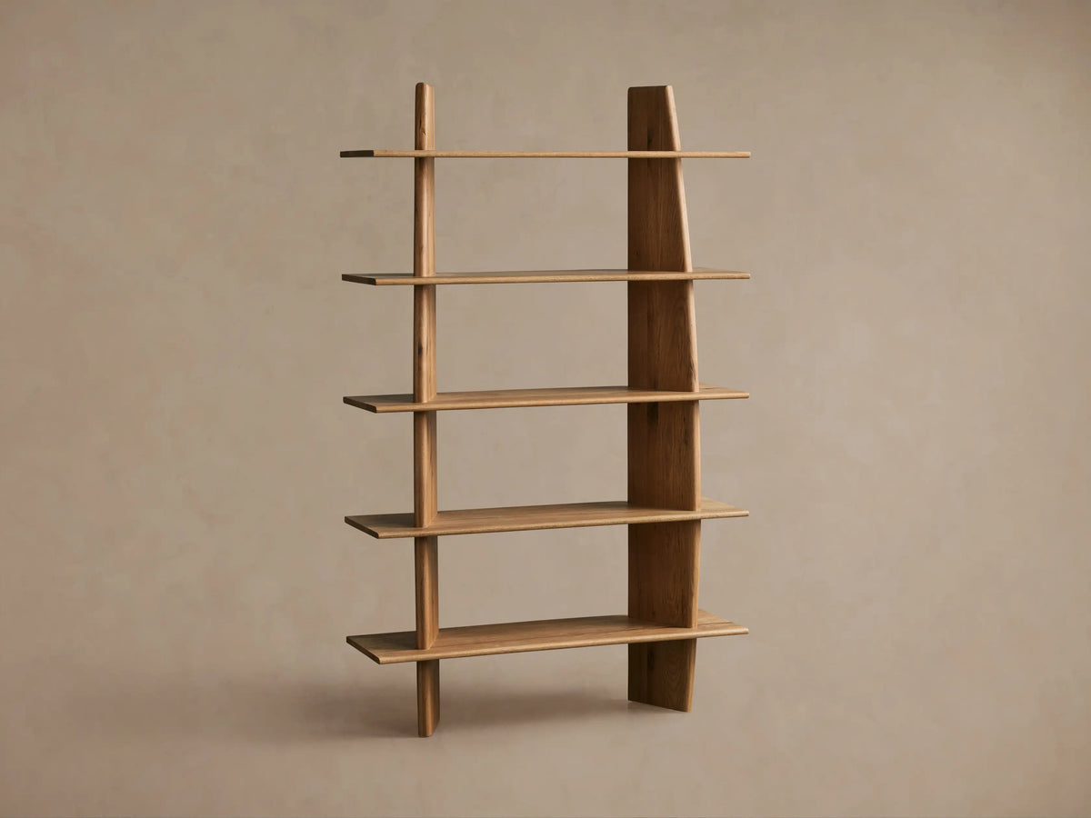 Alt text: Close-up of the Viareggio Bookcase made from solid oak wood, featuring its natural grain, with two shelves displaying decorative items like a textured vase and small golden pot.