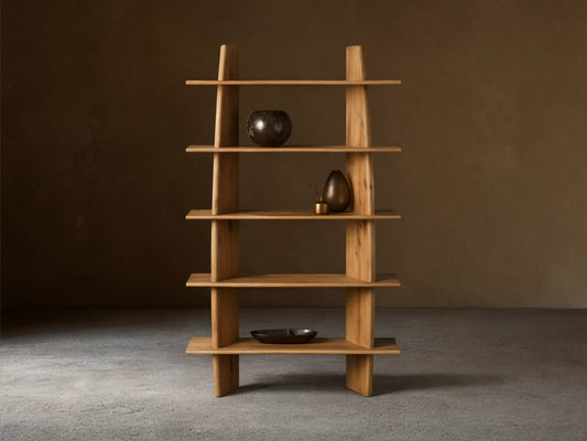 Viareggio Bookcase made of solid oak wood with five fixed shelves, displaying decorative items, against a beige wall.