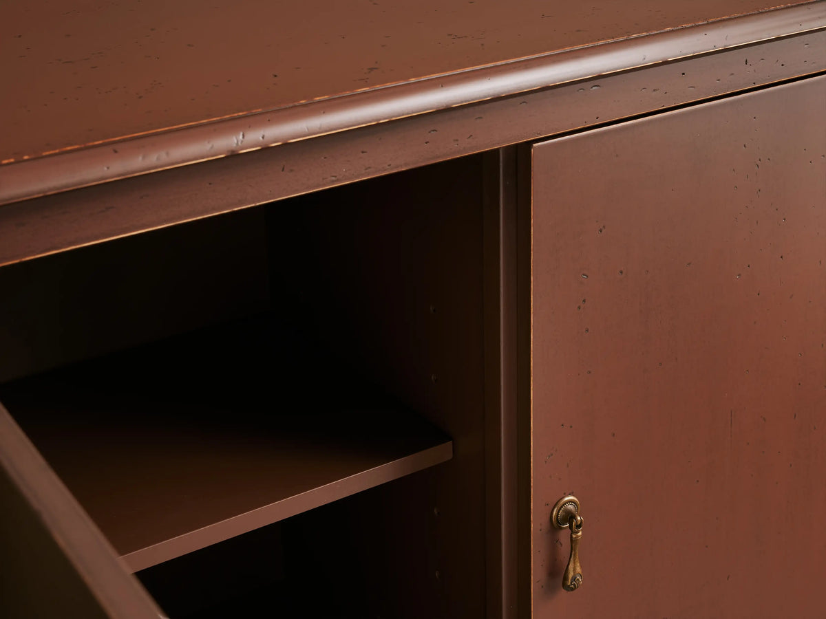 Varzi Cabinet in a warm brown finish with ornate antique-style pendant pulls. Curved legs and scalloped bottom edge.