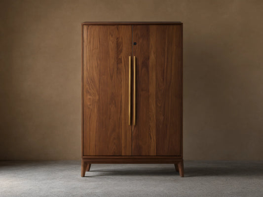 Willard Bar Cabinet, a rich dark brown walnut wood cabinet with two doors and long vertical brass handles, standing on a wooden floor.