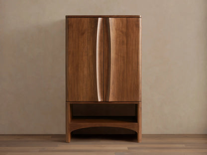 Westyn Bar Cabinet, medium brown wood, two doors with curved vertical finger pulls, and an open lower shelf.