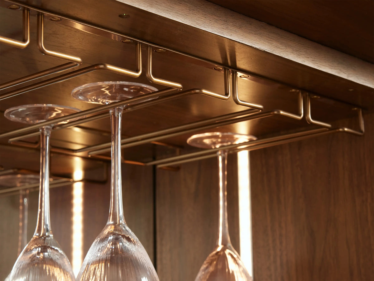 Open Westyn Bar Cabinet, dark wood interior, LED light illuminating bar tools on white marble, liquor, and wine bottles.