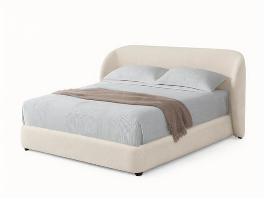Adalynn Bed: Cream boucle upholstered bed with curved headboard, light striped bedding, and a taupe throw on wood floor.
