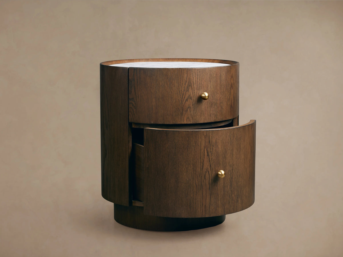 Ashbrook Nightstand in mocha finish with white Carrara marble top. Features two drawers, open bottom drawer, and brass pulls.