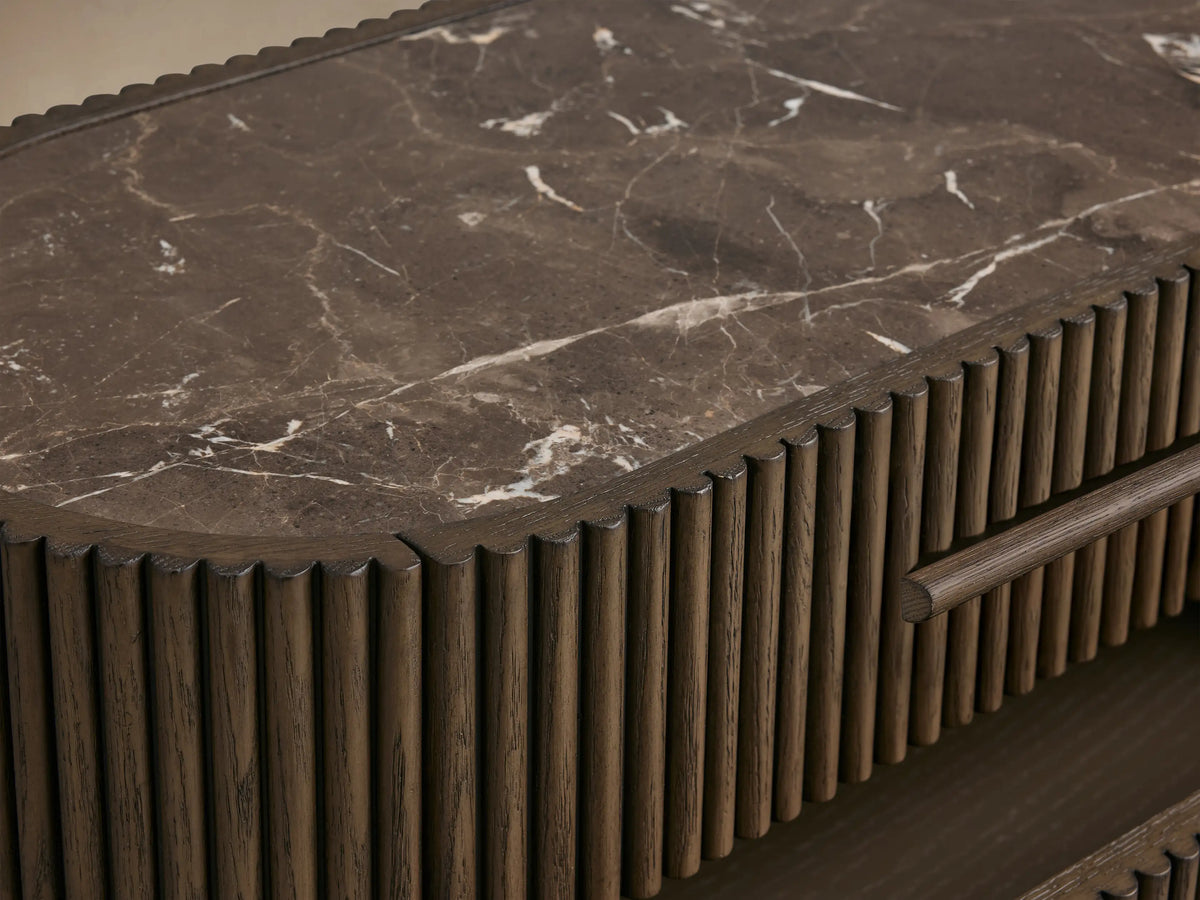 Astor Nightstand, dark oak with vertical reeding, dark marble top. Three drawers, bottom two slightly open, against a light background.