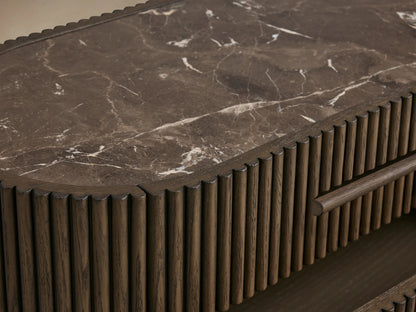 Astor Nightstand, dark oak with vertical reeding, dark marble top. Three drawers, bottom two slightly open, against a light background.