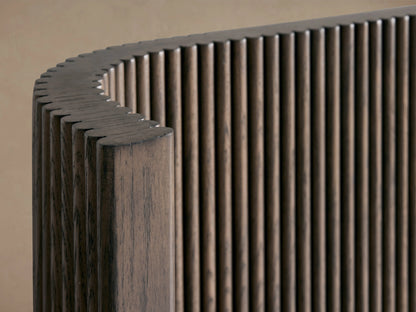 Astor Bed headboard with vertical oak wood reeding detail, curved edge, rich brown finish, close-up view.