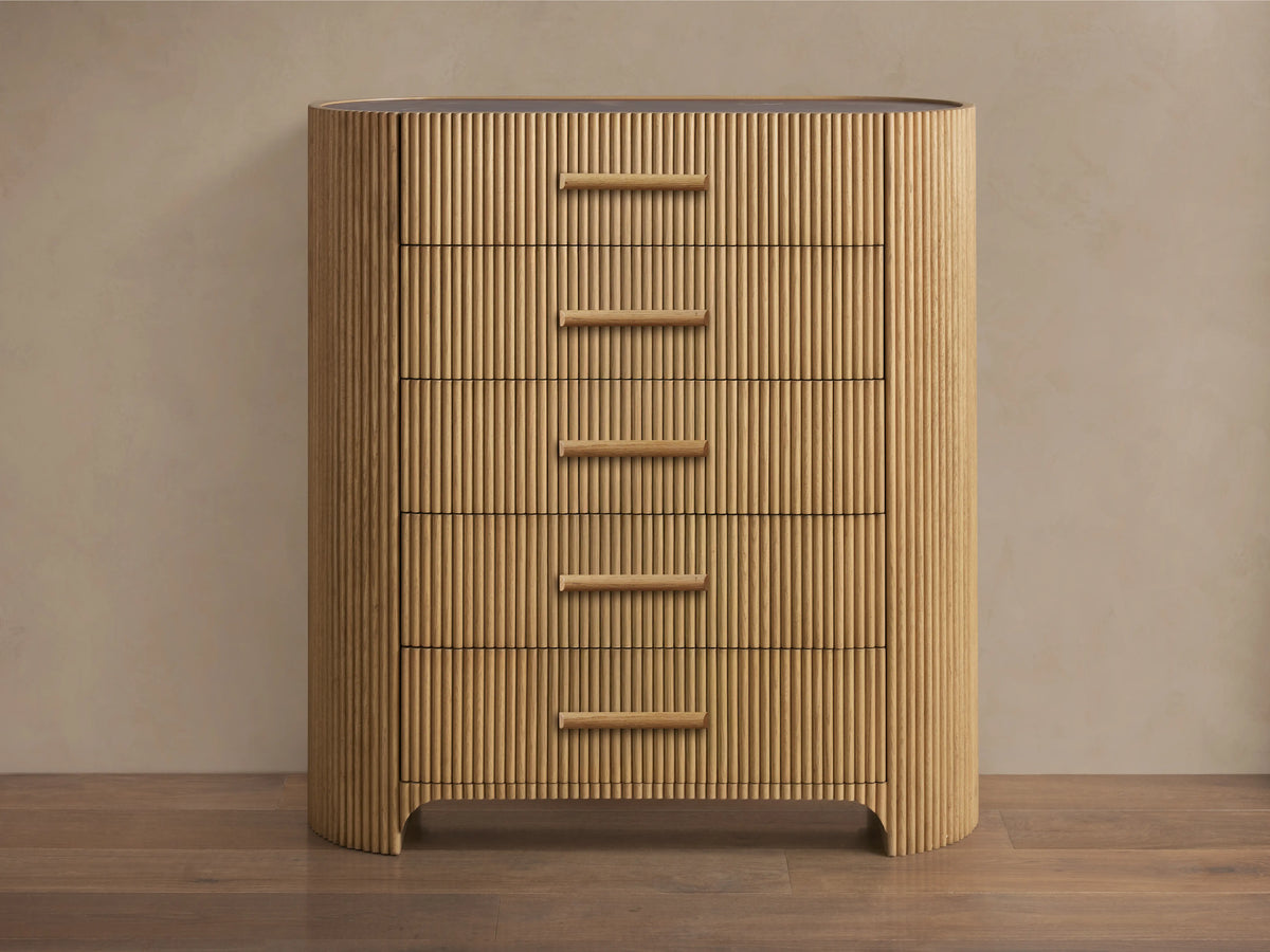 Astor Five-Drawer Dresser with oak wood reeding and natural stone top, featuring five horizontal drawers with stone pulls.