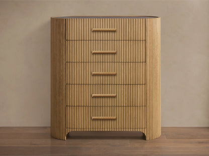 Astor Five-Drawer Dresser with oak wood reeding and natural stone top, featuring five horizontal drawers with stone pulls.