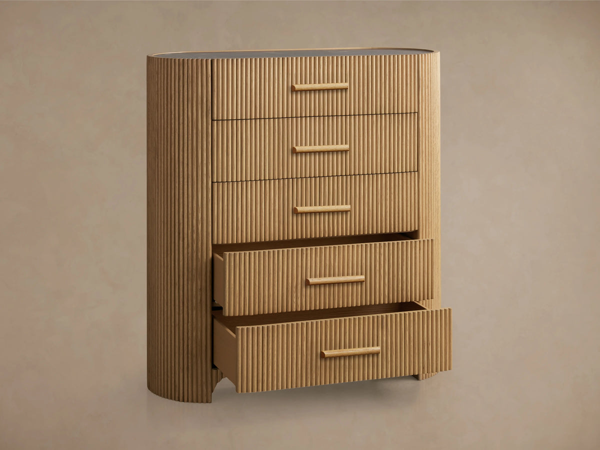 Astor Five-Drawer Dresser with oak wood reeding and natural stone top, featuring five horizontal drawers with stone pulls.
