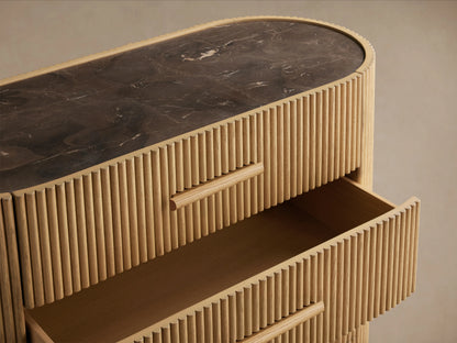 Astor Five-Drawer Dresser made of oak veneers with reeding detail, marble top, and stone pulls; two drawers open, showing its vertical grain.