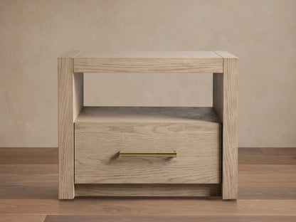 Bodhi Open Nightstand with a light oak finish features a spacious top, open shelf, and single drawer with brass handle.