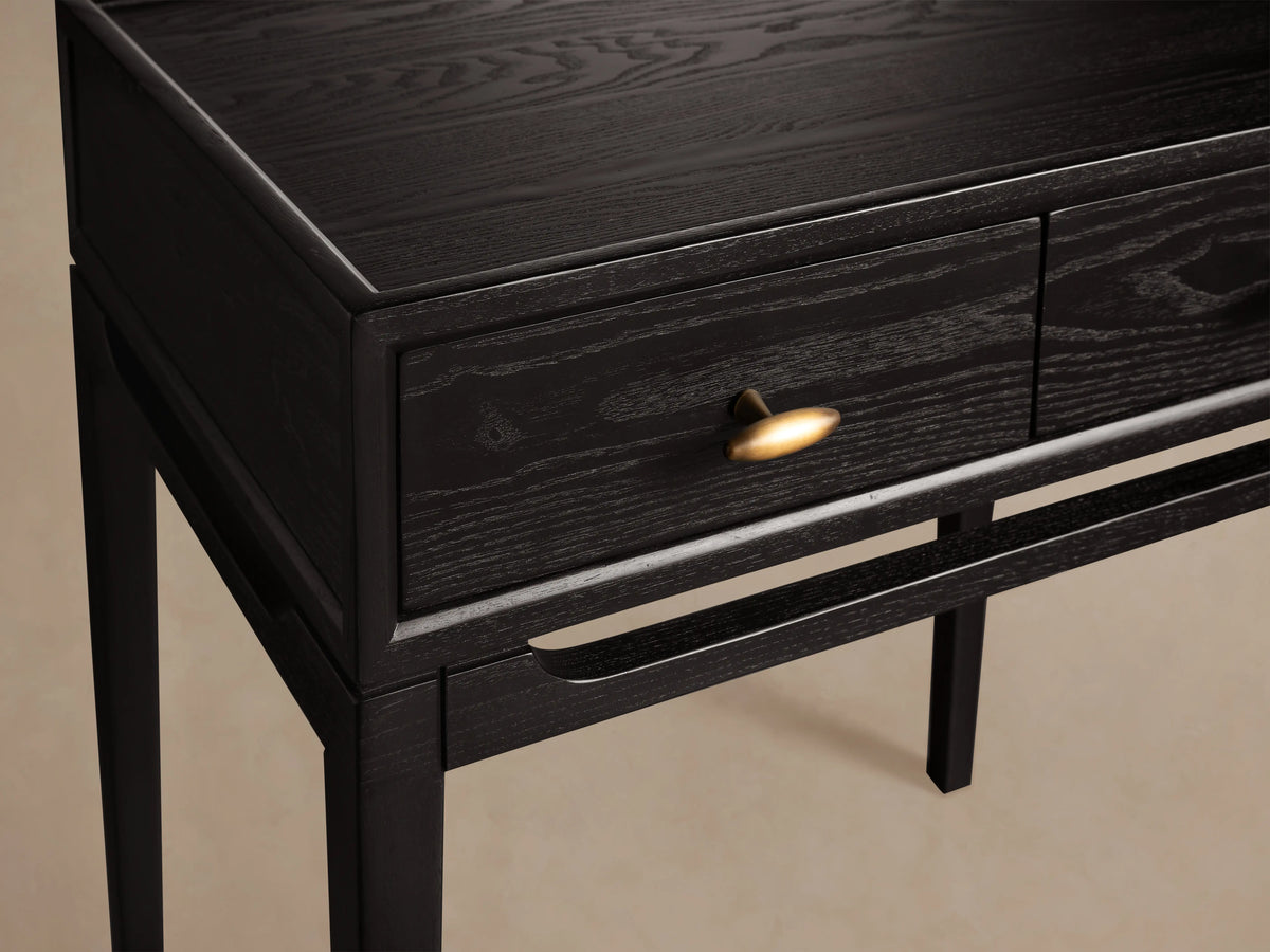 Brock Nightstand made of dark stained ash wood with brushed brass knob, sleek design, and visible wood grain pattern.