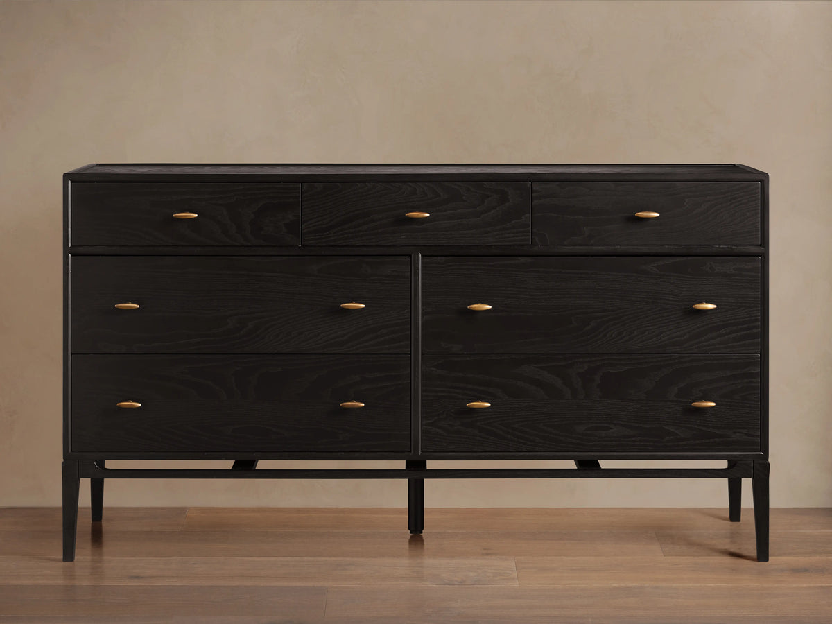 Brock Seven-Drawer Dresser in dark ash wood with a subtle sheen, featuring brushed brass handles, shown against a neutral background.
