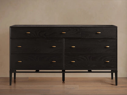 Brock Seven-Drawer Dresser in dark ash wood with a subtle sheen, featuring brushed brass handles, shown against a neutral background.