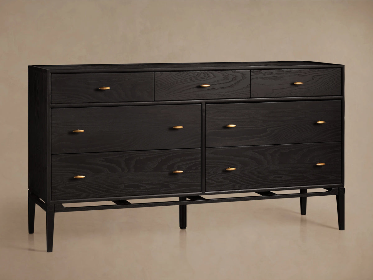 Brock Seven-Drawer Dresser in dark ash wood with brushed brass handles, featuring three top drawers and four larger lower drawers.