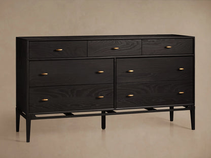 Brock Seven-Drawer Dresser in dark ash wood with brushed brass handles, featuring three top drawers and four larger lower drawers.