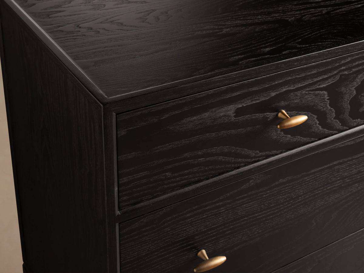 Brock Seven-Drawer Dresser showing dark ash wood finish with visible grain, featuring brushed brass handles.