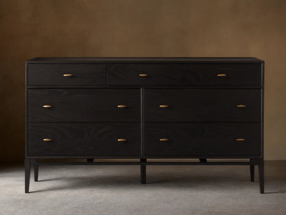 Brock Seven-Drawer Dresser in dark ash wood with a subtle sheen, featuring brushed brass handles, shown against a neutral background.