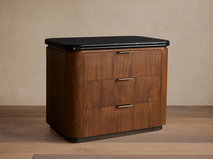 Caden Nightstand: Rounded dark walnut veneer, black marble top, 3 drawers with antique bronze edge-pull hardware.