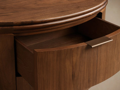 Front view of the walnut Caden Wood Oval Nightstand, featuring an oval top, two drawers with antique bronze edge-pull hardware.