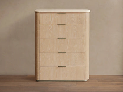 Caden Five-Drawer Dresser with sand oak veneer, rounded edges, white stone top, and five drawers with pewter edge-pull hardware.